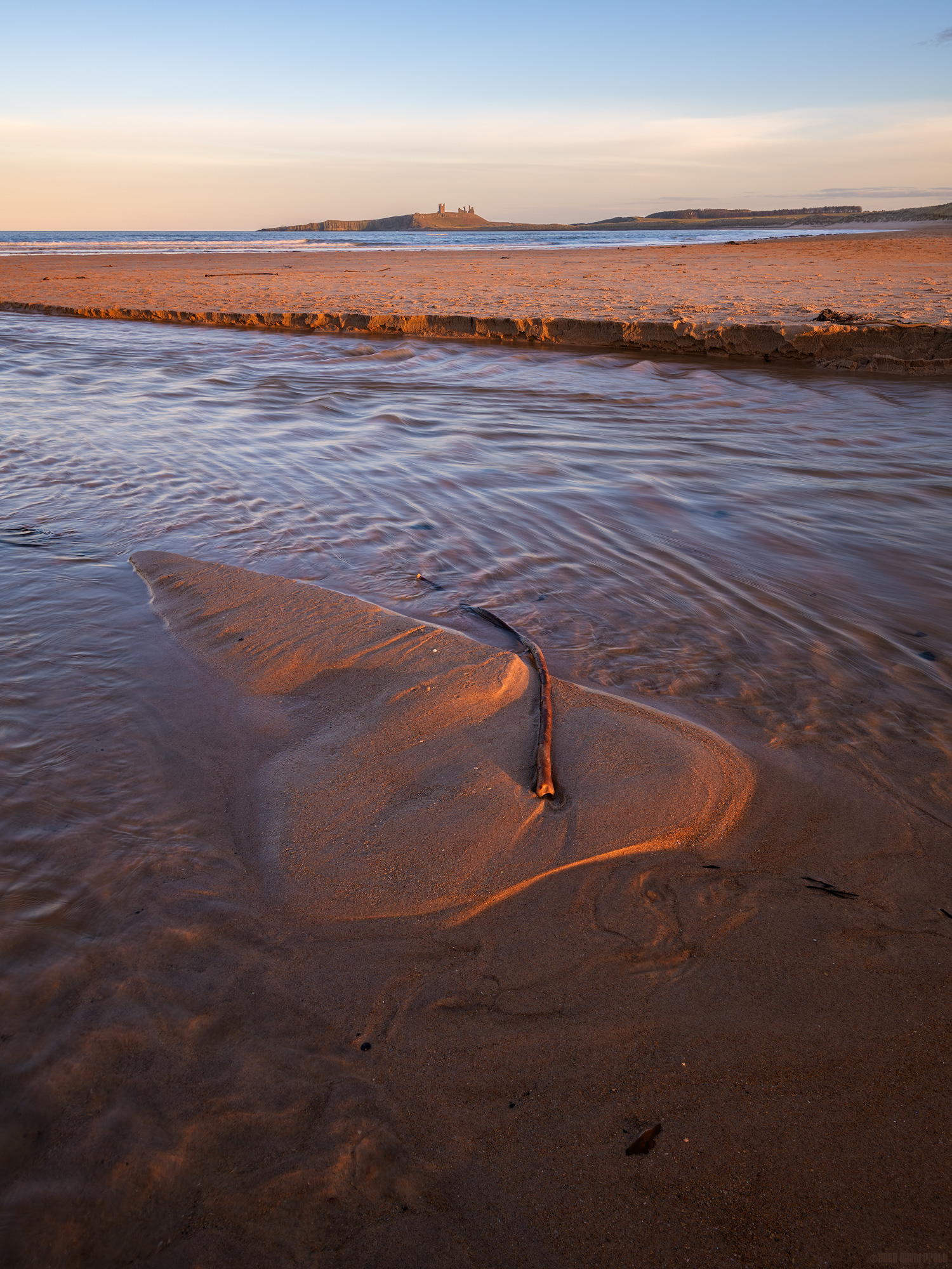 Dunstanburgh In The Distance